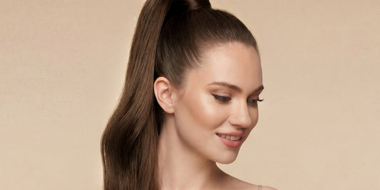 Woman wearing a sleek caramel brown ponytail extension by Bombay Hair
