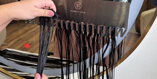 Rinsing Bombay Hair extensions on a holder before washing and care